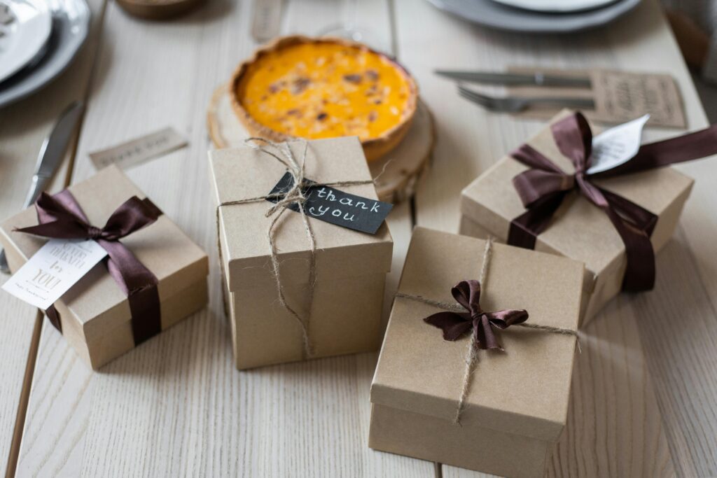 Rustic gift boxes with thank you notes on a wooden table, perfect for celebration and gifting occasions.