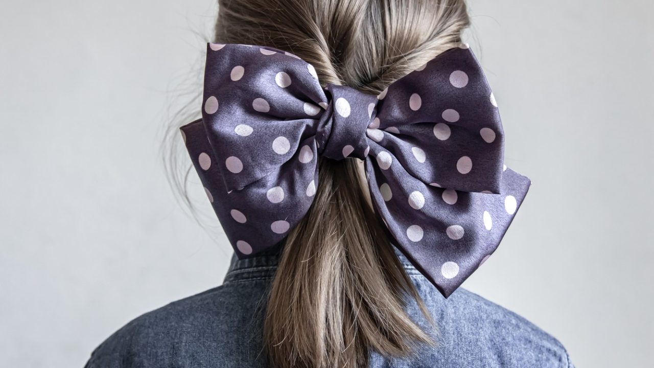 back-view-portrait-schoolgirl-with-beautiful-blue-polka-dot-bow-her-hair